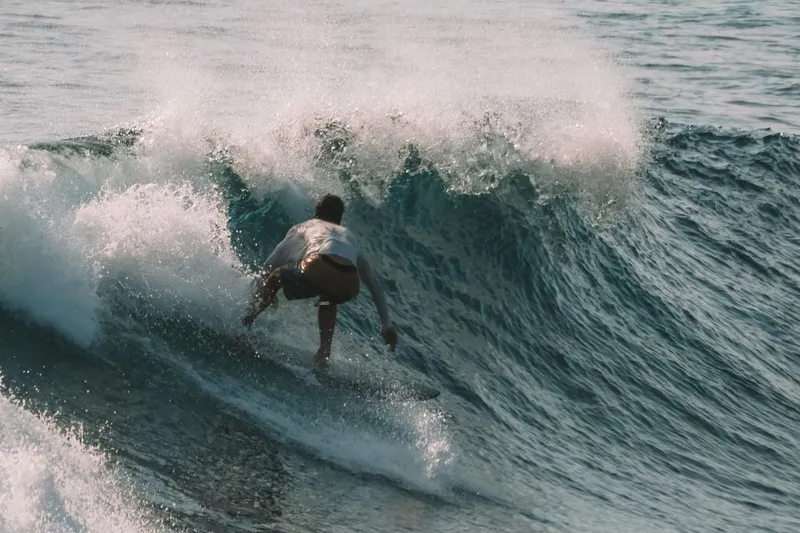 Surfer riding a wave in Bali