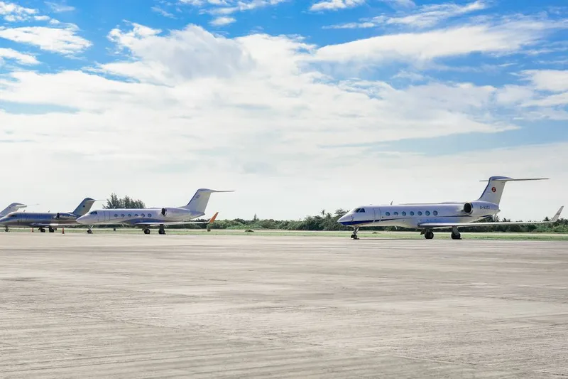 Private jets parked on an airport runway