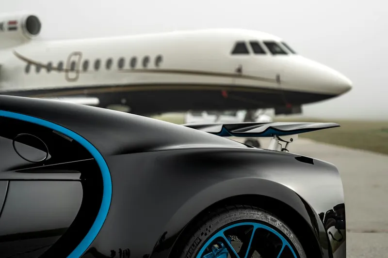 Car parked near an aircraft on an airport apron