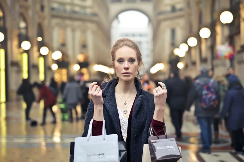 Woman carrying shopping bags in Milan's Galleria Vittorio Emanuele II